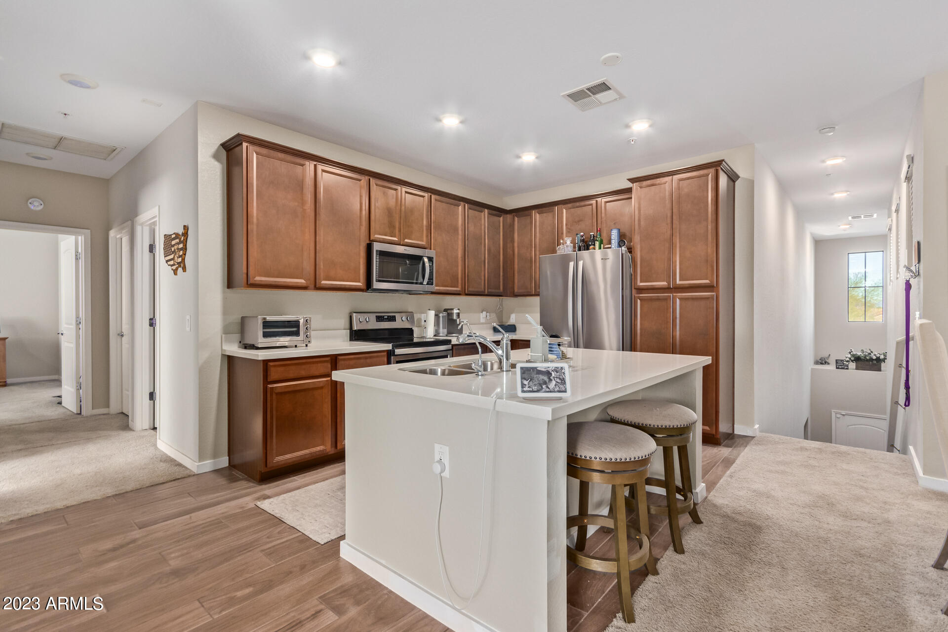3900 East Baseline Road, Unit 168 Phoenix, AZ 85042 - Photo 4 of 19 a kitchen with kitchen island a refrigerator and a stove top oven