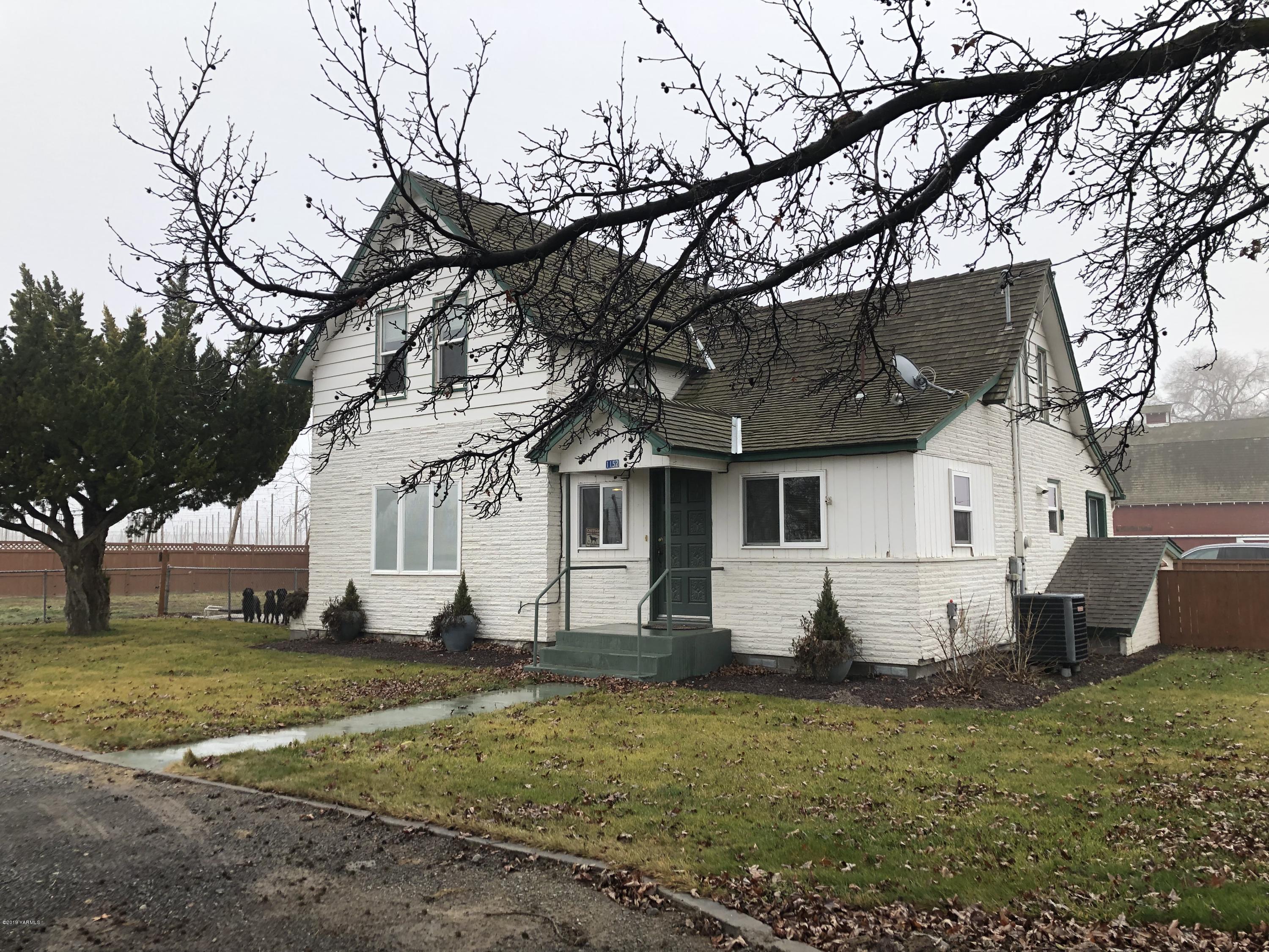 1152 South Rivard Road Moxee, WA 98936 - Photo 1 of 46 a view of a white house with a yard