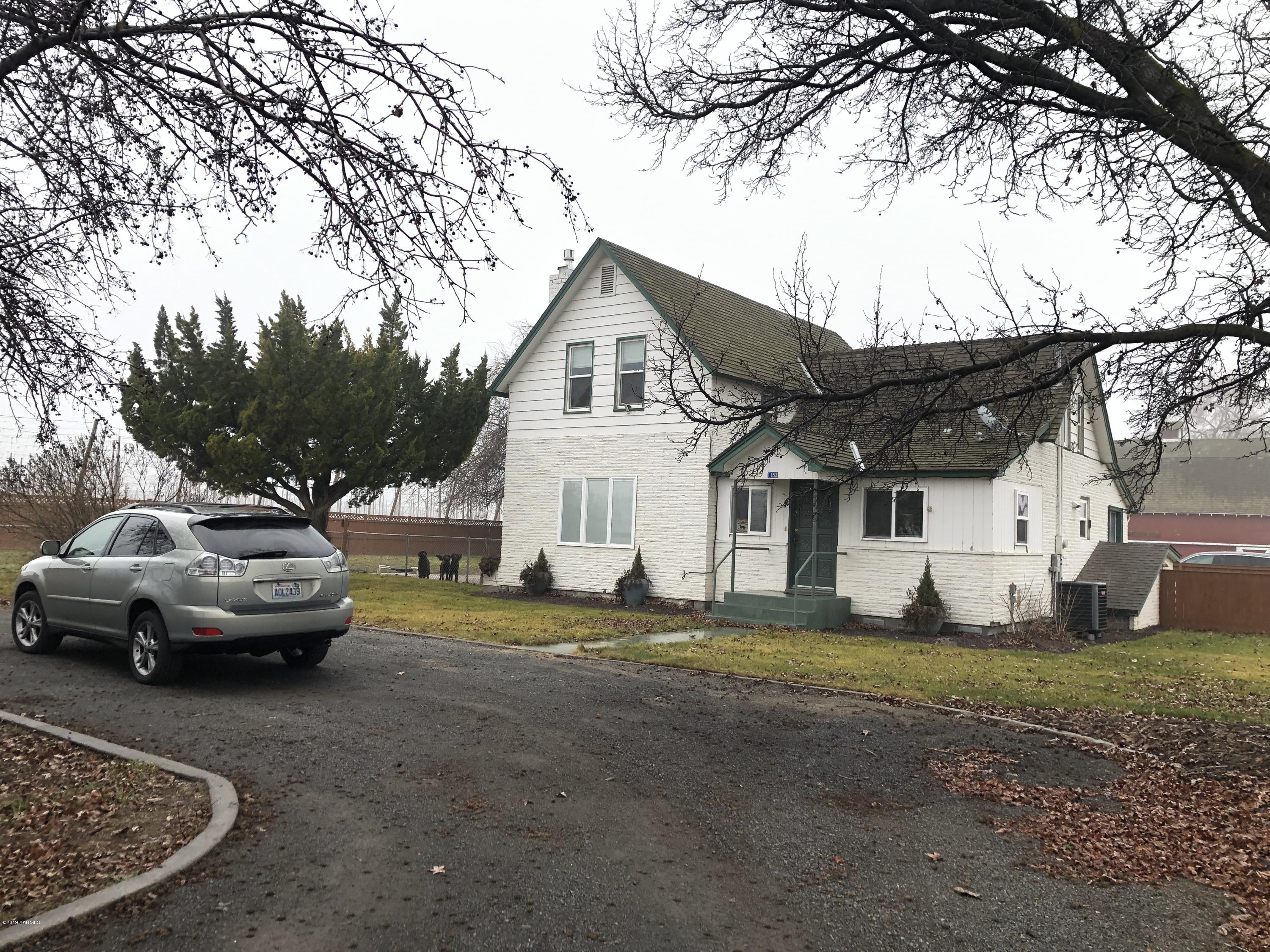 1152 South Rivard Road Moxee, WA 98936 - Photo 2 of 46 a view of a car parked in front of white house