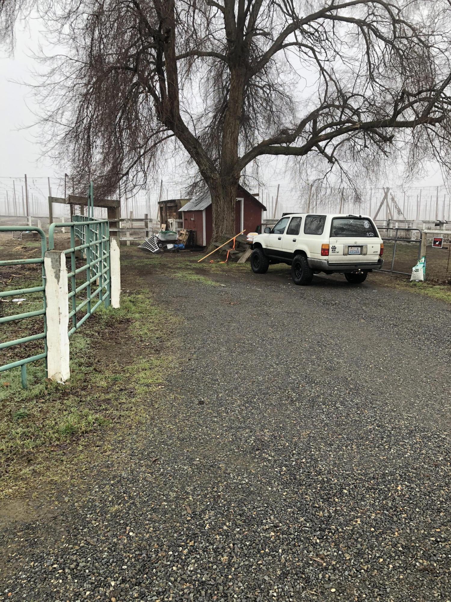 1152 South Rivard Road Moxee, WA 98936 - Photo 15 of 46 a car parked in front of white house