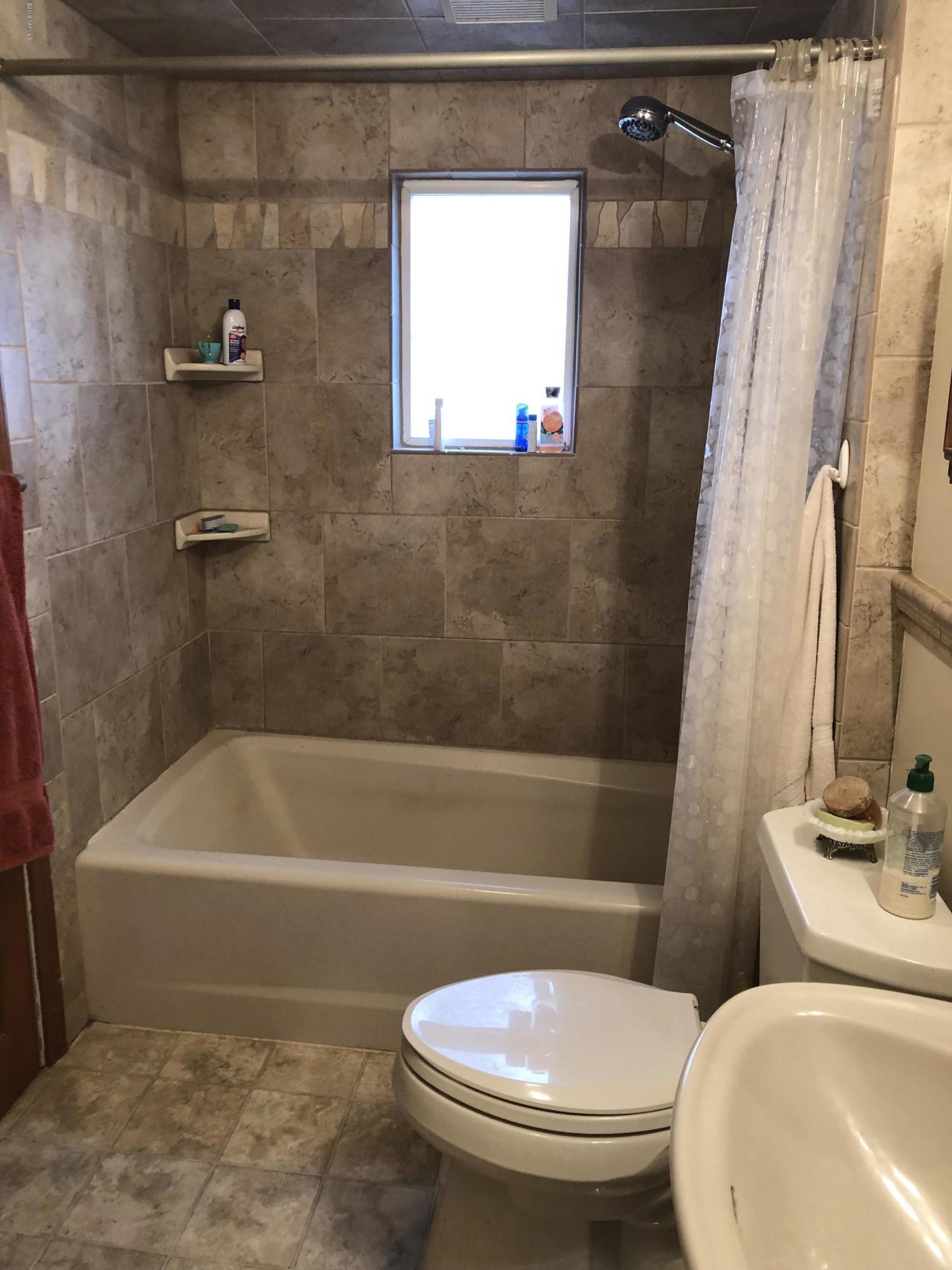 1152 South Rivard Road Moxee, WA 98936 - Photo 28 of 46 a white toilet sitting next to a bath tub and a shower