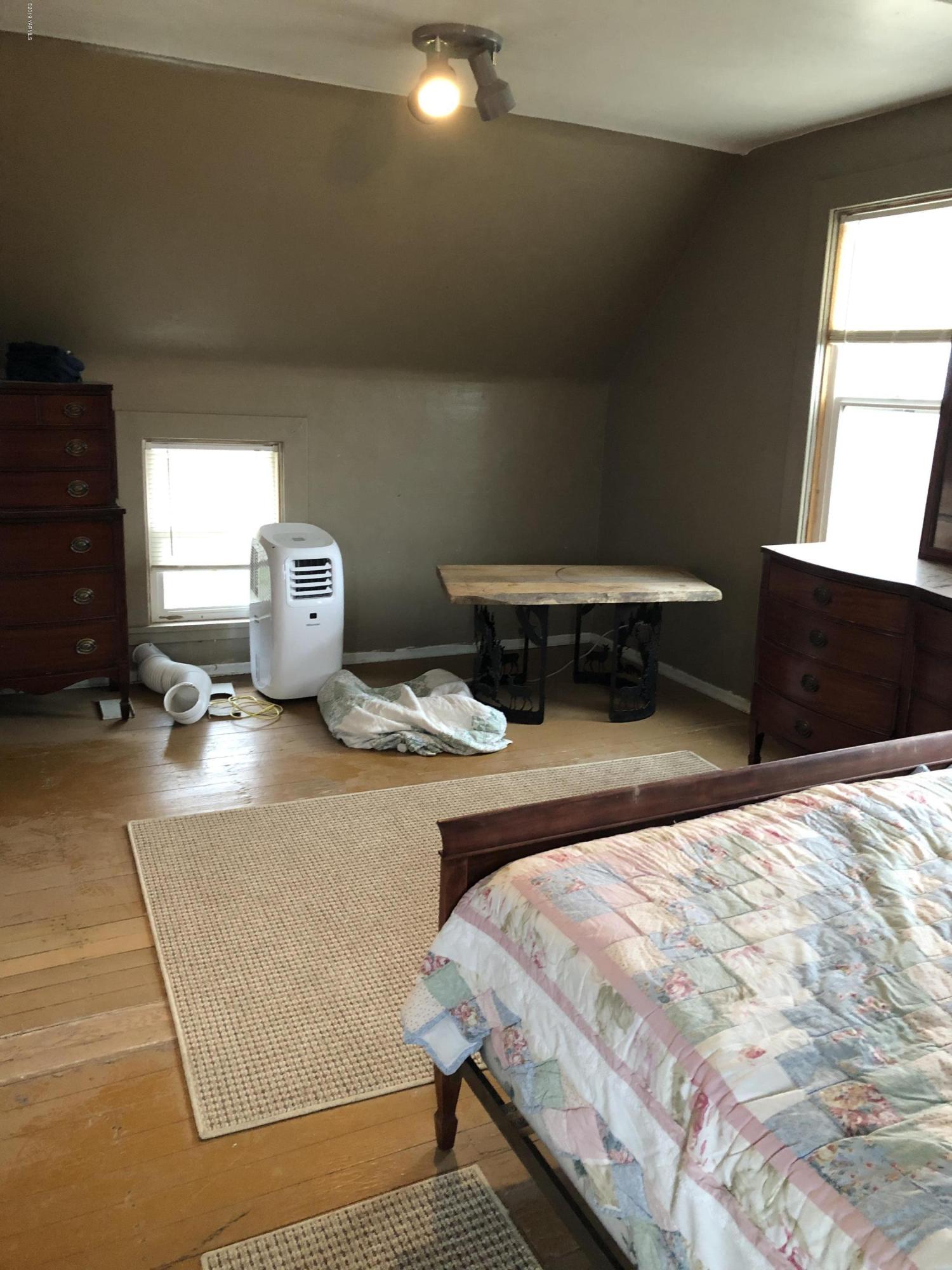 1152 South Rivard Road Moxee, WA 98936 - Photo 39 of 46 a bedroom with a bed and wooden floor