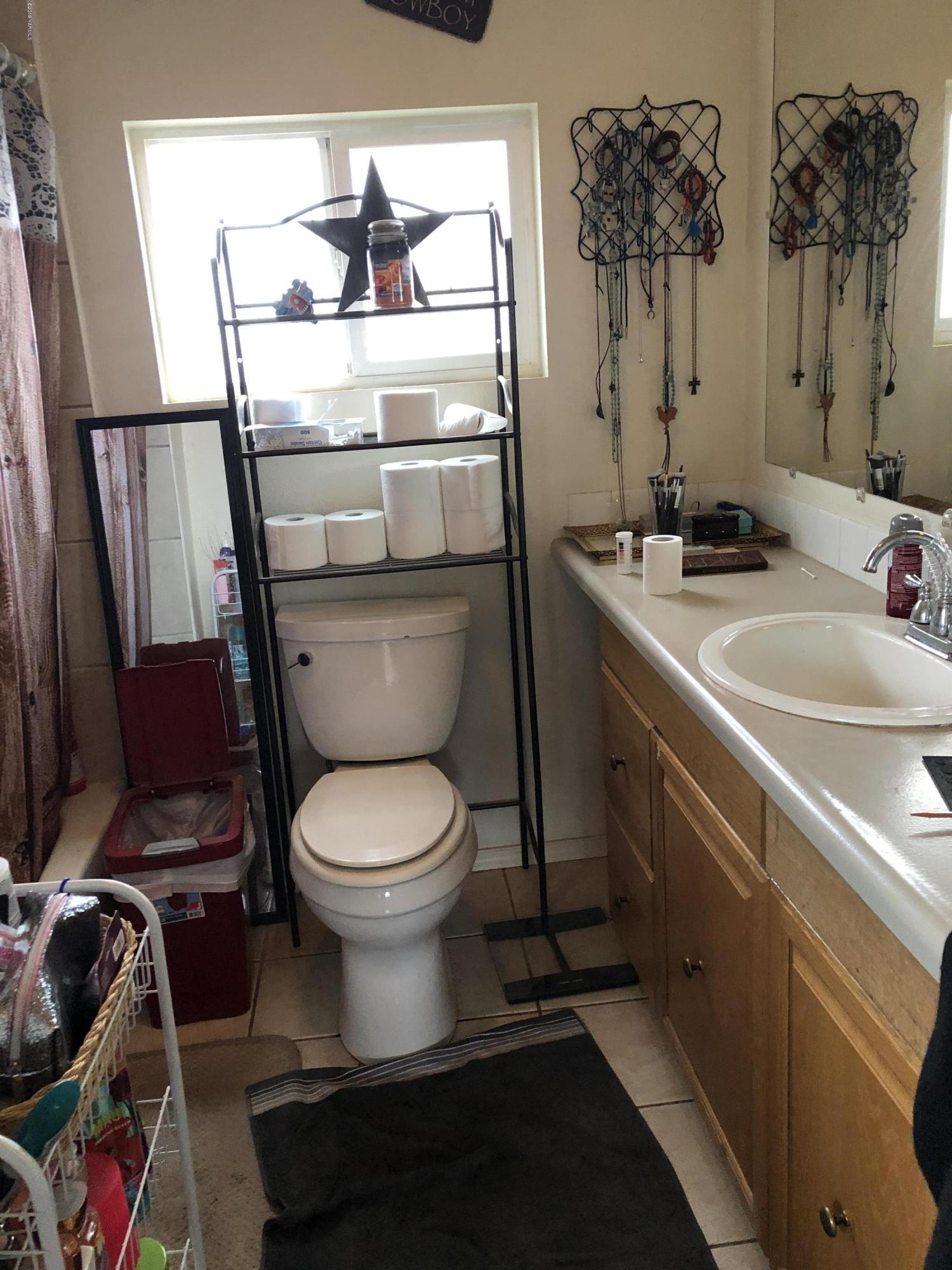 1152 South Rivard Road Moxee, WA 98936 - Photo 41 of 46 a bathroom with a toilet a sink and a mirror