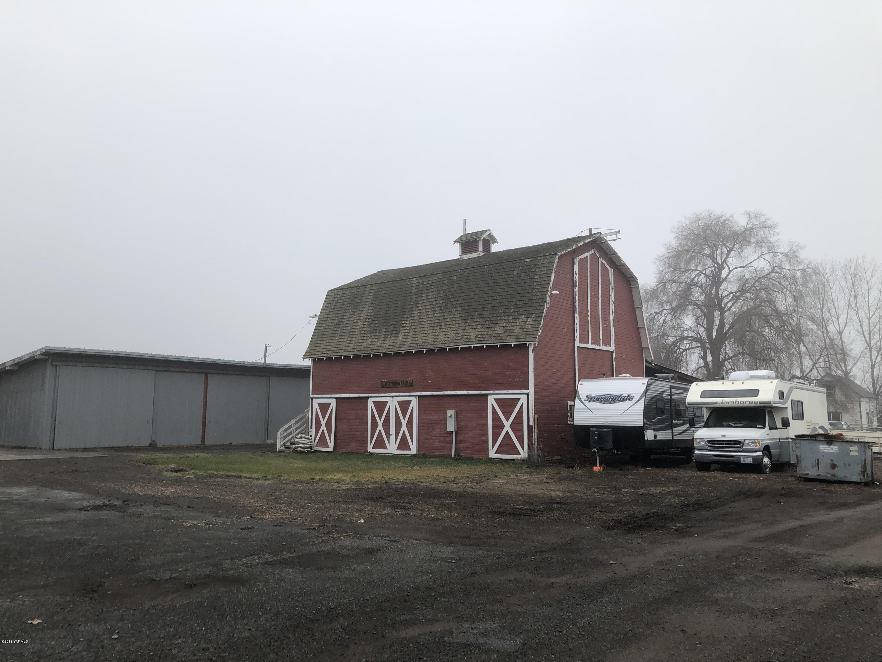 1152 South Rivard Road Moxee, WA 98936 - Photo 7 of 46 a view of a house with truck parked on the road