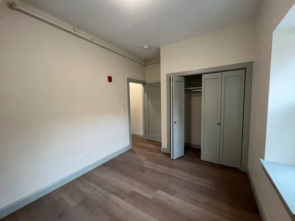 a view of hallway with wooden floor