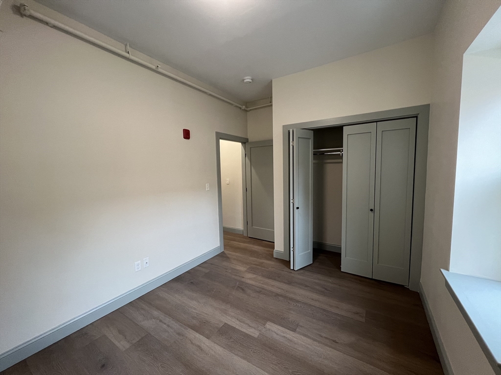 160 Seabury Street, Unit 4 Fall River, MA 02720 - Photo 5 of 10 a view of hallway with wooden floor