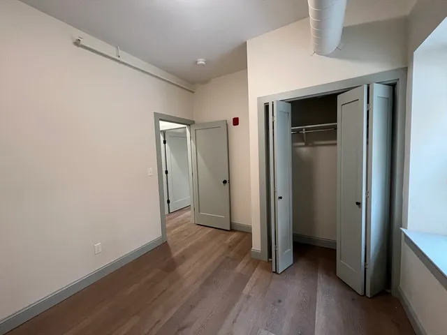 a view of hallway with wooden floor