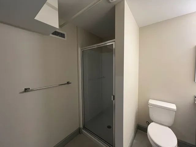 a bathroom with a toilet and a shower