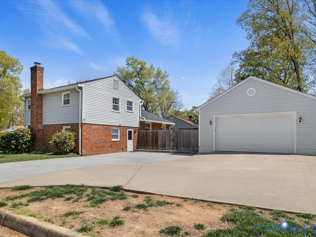 1455 Robindale Road Richmond, VA 23235 - Photo 23 of 29 a front view of a house with a yard and garage