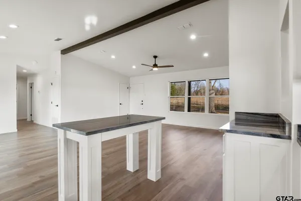 a kitchen with wooden floor and window