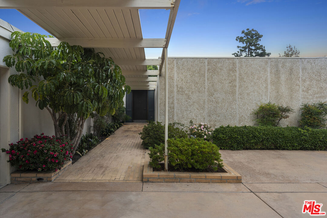 938 North Alpine Drive Beverly Hills, CA 90210 - Photo 6 of 11 a view of a entryway door with flower plants