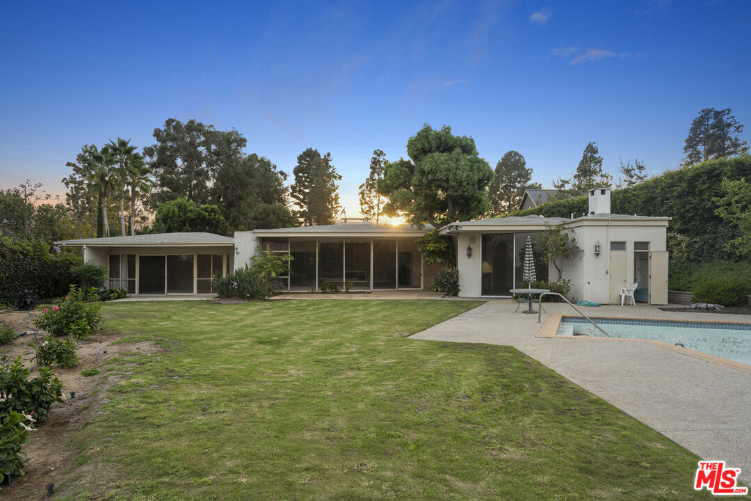 938 North Alpine Drive Beverly Hills, CA 90210 - Photo 10 of 11 a front view of a house with a yard garage and outdoor seating