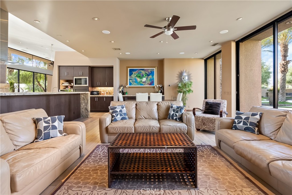 68 Royal St Georges Way Rancho Mirage, CA 92270 - Photo 34 of 75 a living room with furniture ceiling fan and a rug