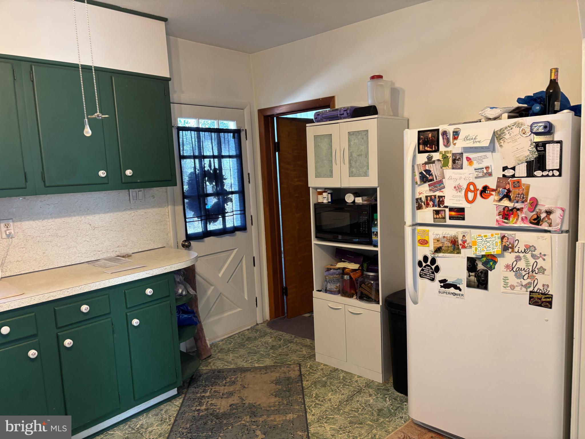 219 North 3rd Street Hanover, PA 17331 - Photo 9 of 12 a kitchen with a refrigerator and cabinets