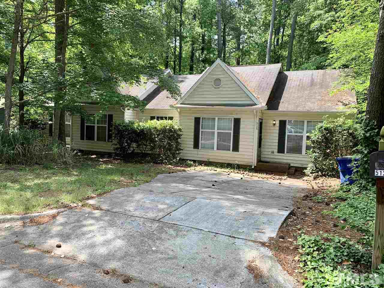 5121 Vann Street Raleigh, NC 27606 - Photo 1 of 12 front view of a house with a yard