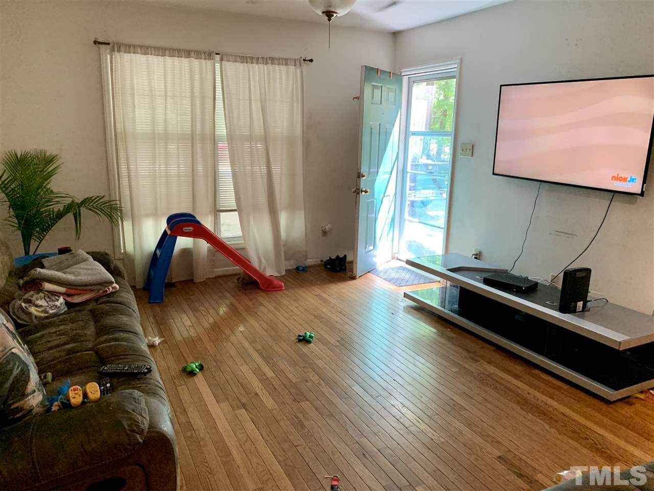 5121 Vann Street Raleigh, NC 27606 - Photo 3 of 12 a living room with furniture and a large window