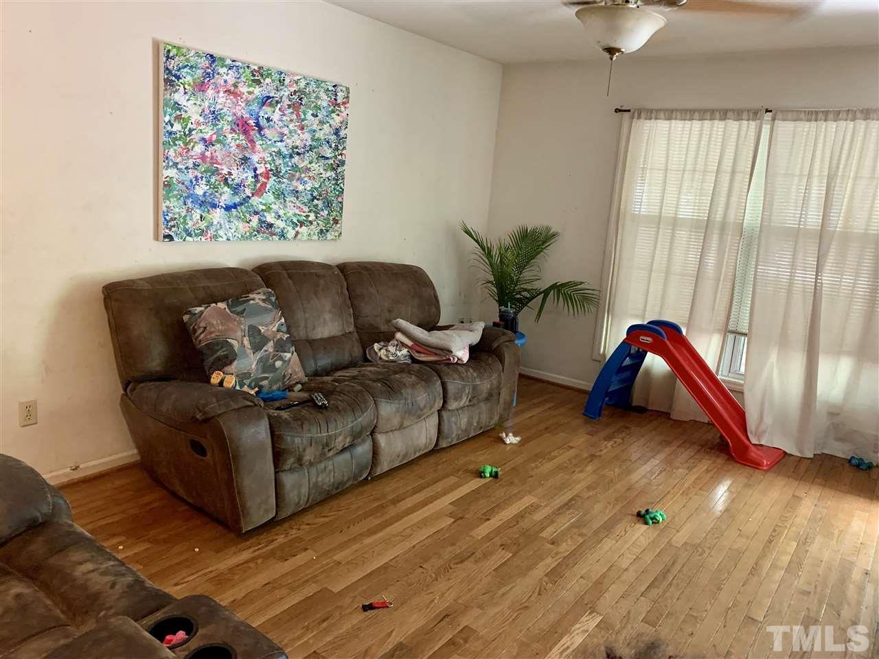 5121 Vann Street Raleigh, NC 27606 - Photo 5 of 12 a living room with furniture rug and a window
