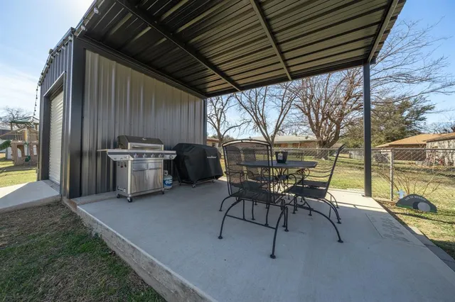 a patio with table and chairs and couches with wooden floor