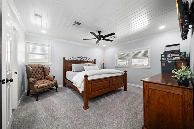 a bedroom with a bed and a painting on the wall