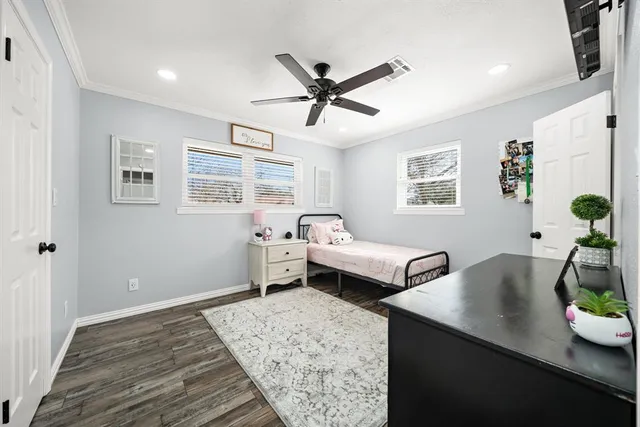 a bedroom with a bed and a dresser in it