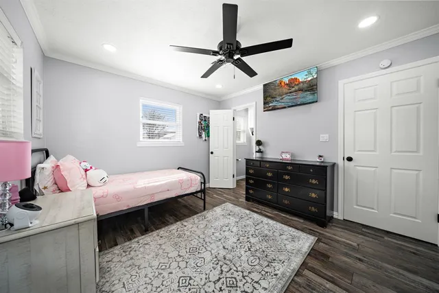 a bathroom with a toilet sink vanity and mirror