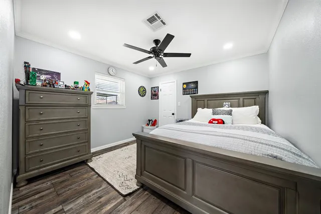 a bedroom with a bed and a dresser in it