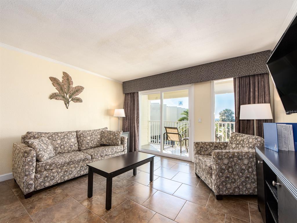 2506 North Rocky Point Drive, Unit 358 Tampa, FL 33607 - Photo 19 of 45 a living room with furniture and a large window