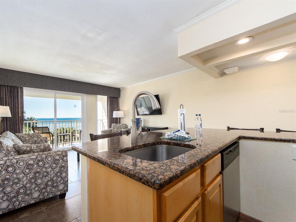 2506 North Rocky Point Drive, Unit 358 Tampa, FL 33607 - Photo 25 of 45 a kitchen with granite countertop a sink and a stove