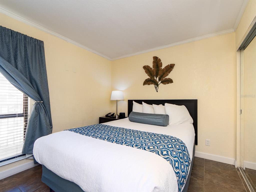 2506 North Rocky Point Drive, Unit 358 Tampa, FL 33607 - Photo 10 of 45 a bedroom with a bed and window