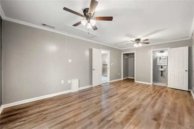 a view of empty room with wooden floor