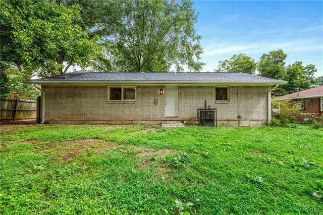 a front view of house with yard and trees