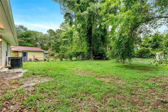 a view of a house with yard and sitting area