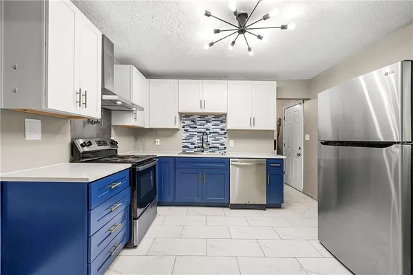 a kitchen with stainless steel appliances granite countertop a refrigerator sink and cabinets