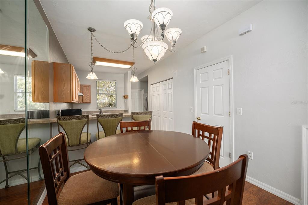 3910 Southwest 20th Avenue, Unit 1403 Gainesville, FL 32607 - Photo 14 of 36 a view of a dining room with furniture and wooden floor