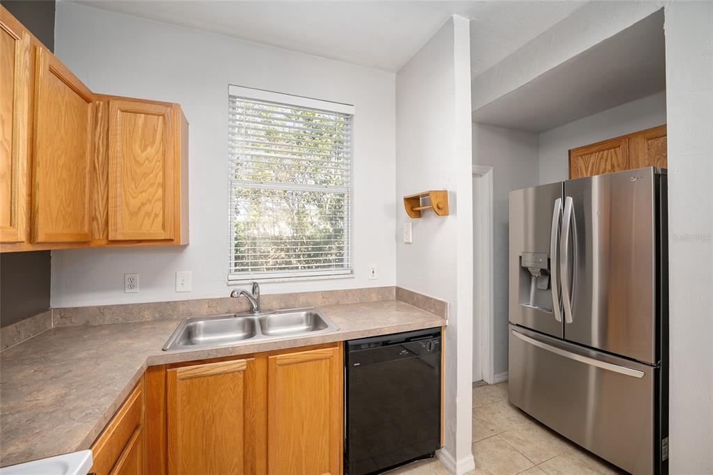 3910 Southwest 20th Avenue, Unit 1403 Gainesville, FL 32607 - Photo 17 of 36 a kitchen with stainless steel appliances granite countertop a refrigerator and a sink