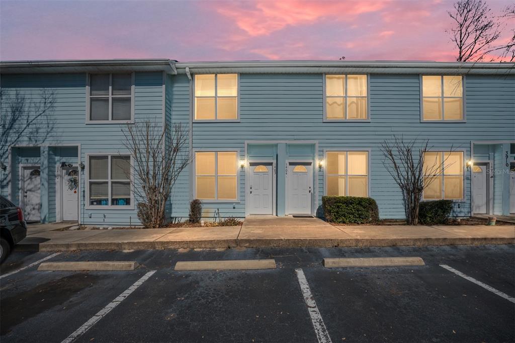 3910 Southwest 20th Avenue, Unit 1403 Gainesville, FL 32607 - Photo 2 of 36 a front view of a house with a yard