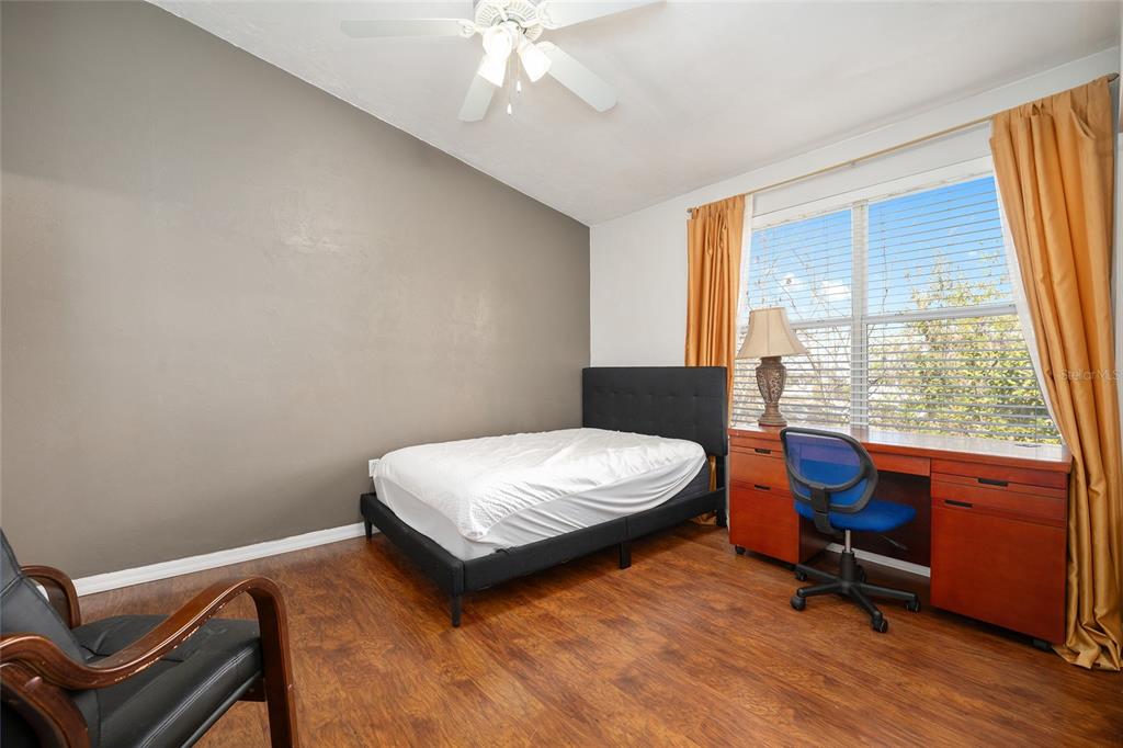 3910 Southwest 20th Avenue, Unit 1403 Gainesville, FL 32607 - Photo 23 of 36 a bedroom with a bed and a window