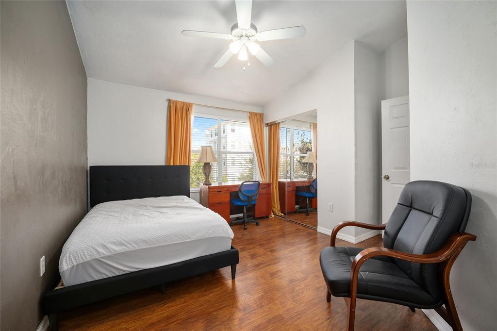 3910 Southwest 20th Avenue, Unit 1403 Gainesville, FL 32607 - Photo 24 of 36 a bedroom with a bed and chair