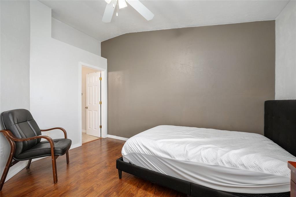 3910 Southwest 20th Avenue, Unit 1403 Gainesville, FL 32607 - Photo 25 of 36 a bedroom with a bed and a chair