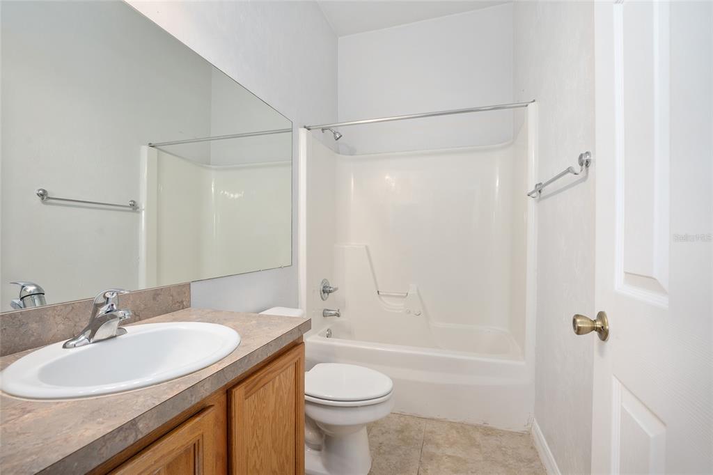 3910 Southwest 20th Avenue, Unit 1403 Gainesville, FL 32607 - Photo 27 of 36 a bathroom with a sink a toilet and shower