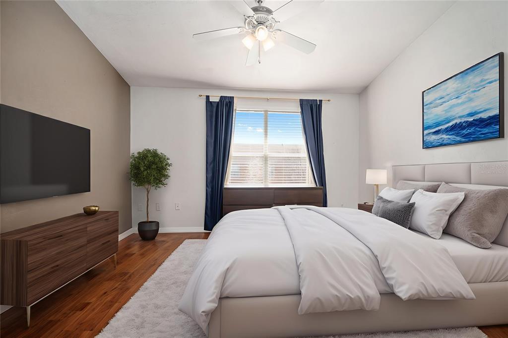 3910 Southwest 20th Avenue, Unit 1403 Gainesville, FL 32607 - Photo 29 of 36 a bedroom with a bed and a flat screen tv