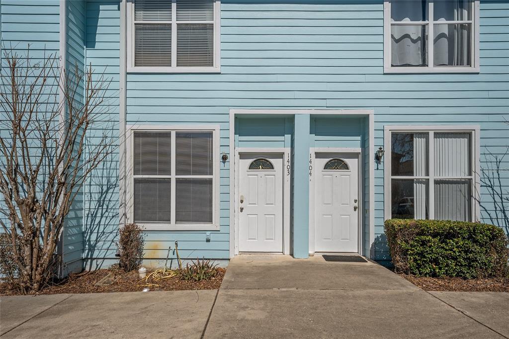 3910 Southwest 20th Avenue, Unit 1403 Gainesville, FL 32607 - Photo 3 of 36 a front view of a house with a yard