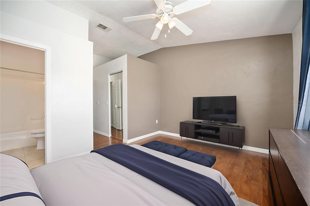 3910 Southwest 20th Avenue, Unit 1403 Gainesville, FL 32607 - Photo 31 of 36 a bedroom with a bed and a flat screen tv