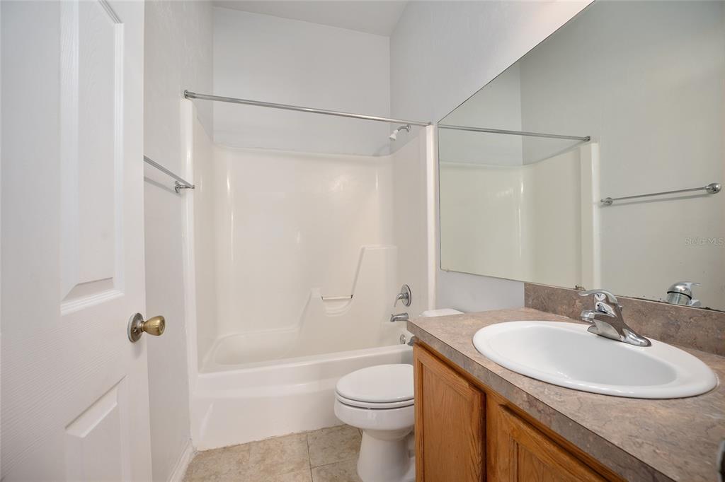 3910 Southwest 20th Avenue, Unit 1403 Gainesville, FL 32607 - Photo 32 of 36 a bathroom with a sink toilet and shower