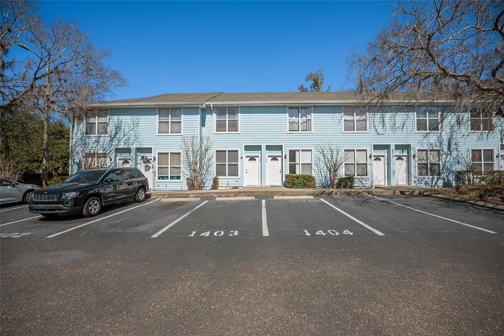 3910 Southwest 20th Avenue, Unit 1403 Gainesville, FL 32607 - Photo 34 of 36 a couple of cars parked in front of a house