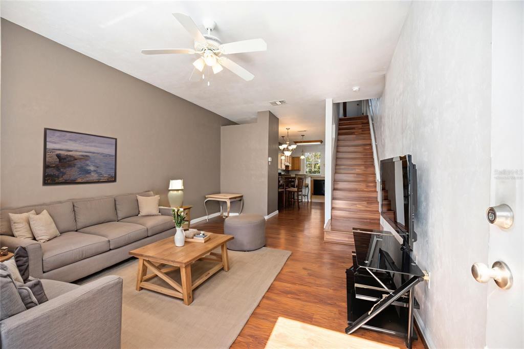3910 Southwest 20th Avenue, Unit 1403 Gainesville, FL 32607 - Photo 7 of 36 a living room with furniture and wooden floor