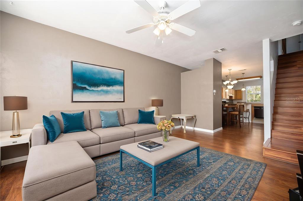 3910 Southwest 20th Avenue, Unit 1403 Gainesville, FL 32607 - Photo 8 of 36 a living room with furniture a rug and a chandelier