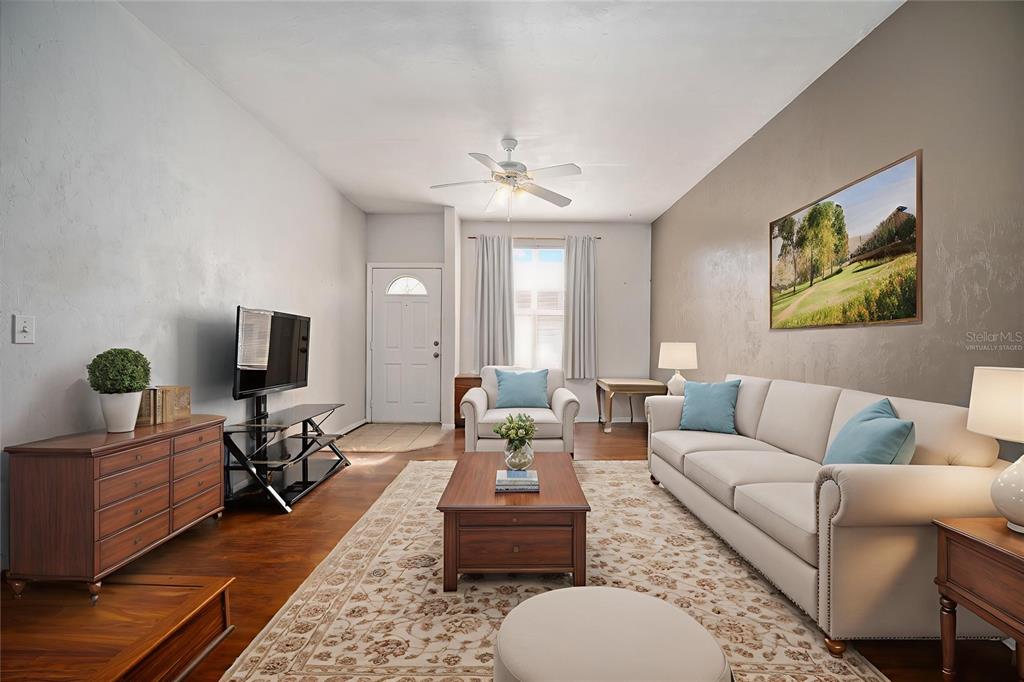 3910 Southwest 20th Avenue, Unit 1403 Gainesville, FL 32607 - Photo 9 of 36 a living room with furniture and a flat screen tv