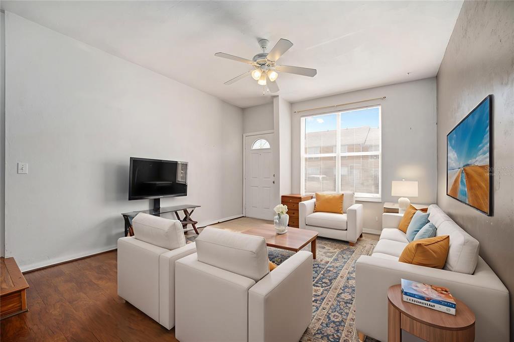 3910 Southwest 20th Avenue, Unit 1403 Gainesville, FL 32607 - Photo 10 of 36 a living room with furniture and a flat screen tv