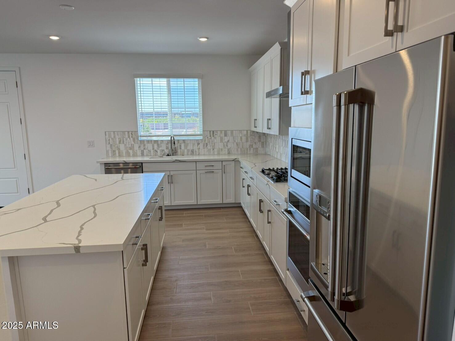 2443 West Rowel Road Phoenix, AZ 85085 - Photo 8 of 19 a kitchen with stainless steel appliances a refrigerator and a sink